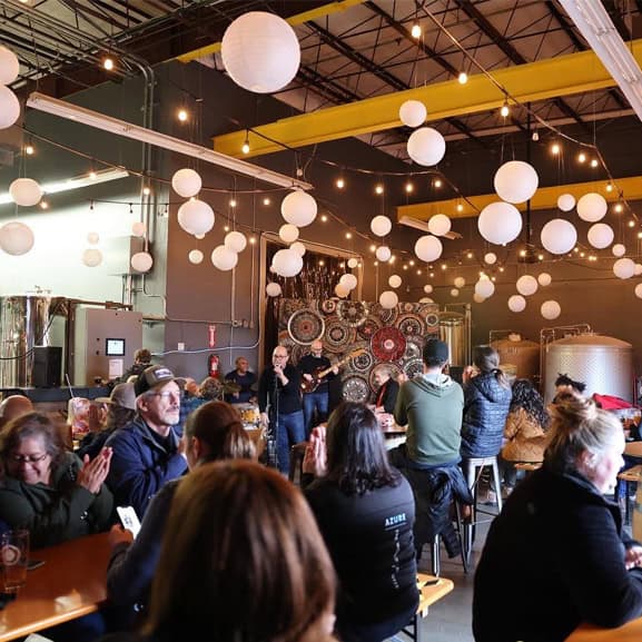 A live band playing for a full bar of customers.