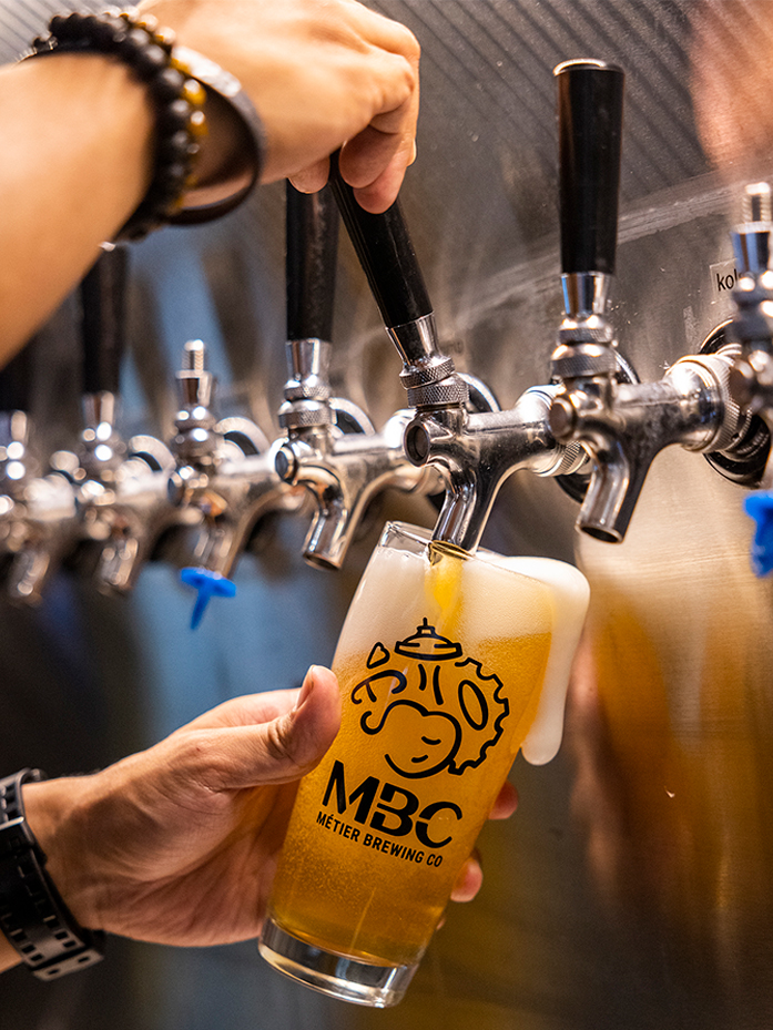 A glass being filled at the beer tap.